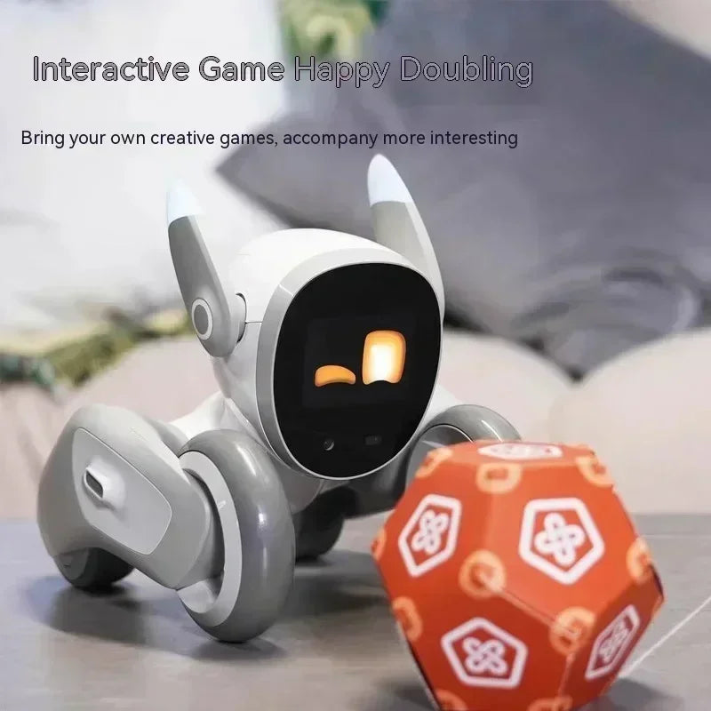Interactive robot toy with display screen and wheels next to an orange dodecahedron game die.