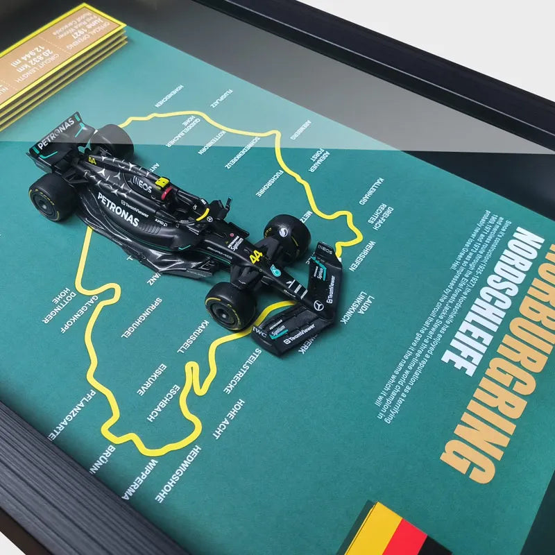 Framed Nürburgring circuit map with Mercedes F1 model car showcasing track details.