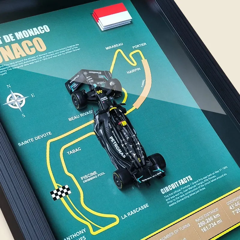 Monaco Grand Prix circuit map with F1 car model, showing track layout including Sainte Devote, hairpin, and swimming pool sections.