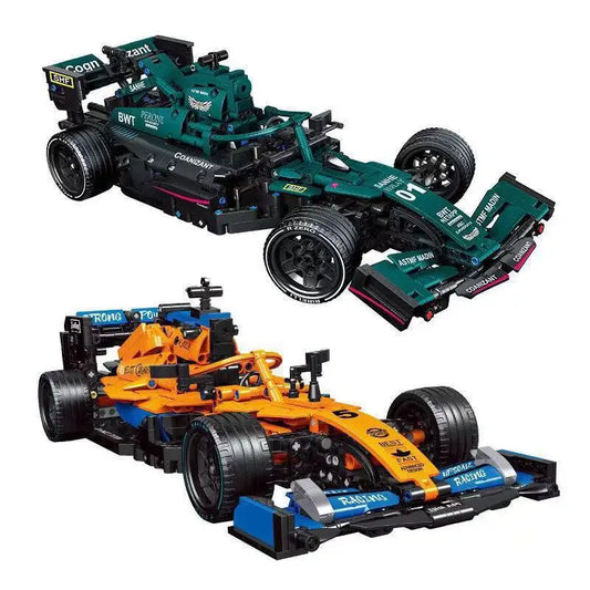 Two toy Formula 1 race cars: a green Aston Martin and an orange McLaren, showcasing their detailed construction.
